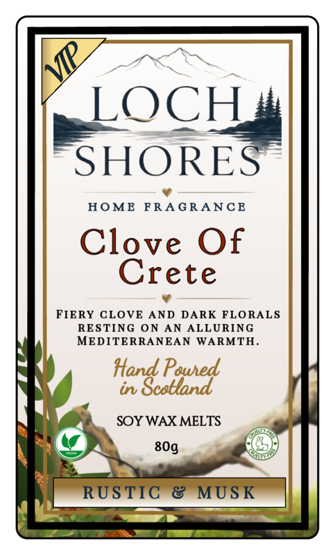 Front-facing product label for Loch Shores Home Fragrance 'Clove Of Crete' soy wax melts, with a cream background, dark blue mountain-and-water illustration, brown and gold typography, and rustic botanical accents. Visible brand: Loch Shores.