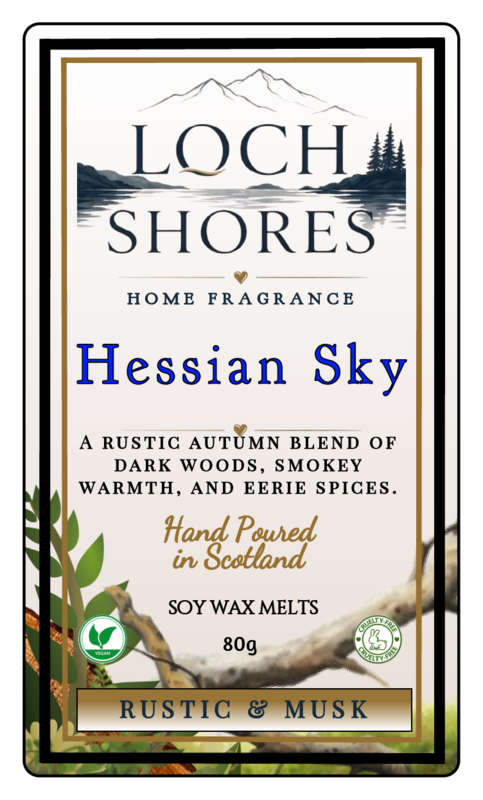 Front-facing product label for Loch Shores Home Fragrance 'Hessian Sky' soy wax melts, with mountain and lake artwork, blue title text, and rustic autumn-themed decorative elements on a cream background.
