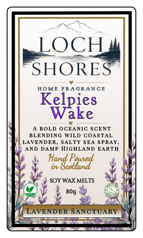 Front of a Loch Shores home fragrance product label for Kelpies Wake, lavender sanctuary soy wax melts, 80g. The label features a cream background with black and purple typography, a mountain and lake illustration at the top, and purple lavender illustrations along the bottom border.